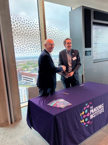 Dr Julian Braybrook, Director of the National Measurement Laboratory at LGC and professor Tom Solomon, CBE. Director of The Pandemic Institute shaking hands
